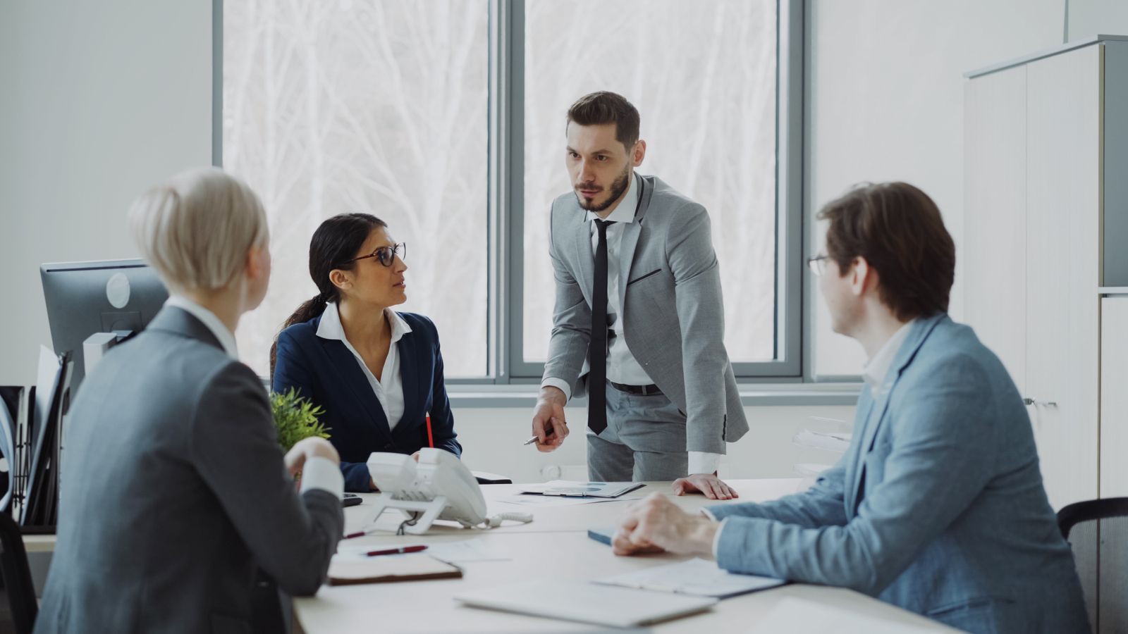 Executives discussing strategy in a modern office